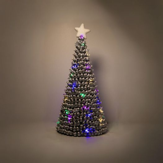 Silver christmas tree with white ornaments, multicolored lights and white star.