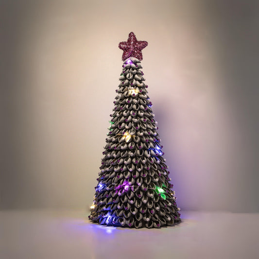 Silver Christmas tree with purple ornaments, purple star and multicolored lights.