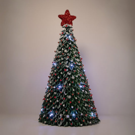 Green Christmas tree with red ornaments, red star, white lights and snow details.