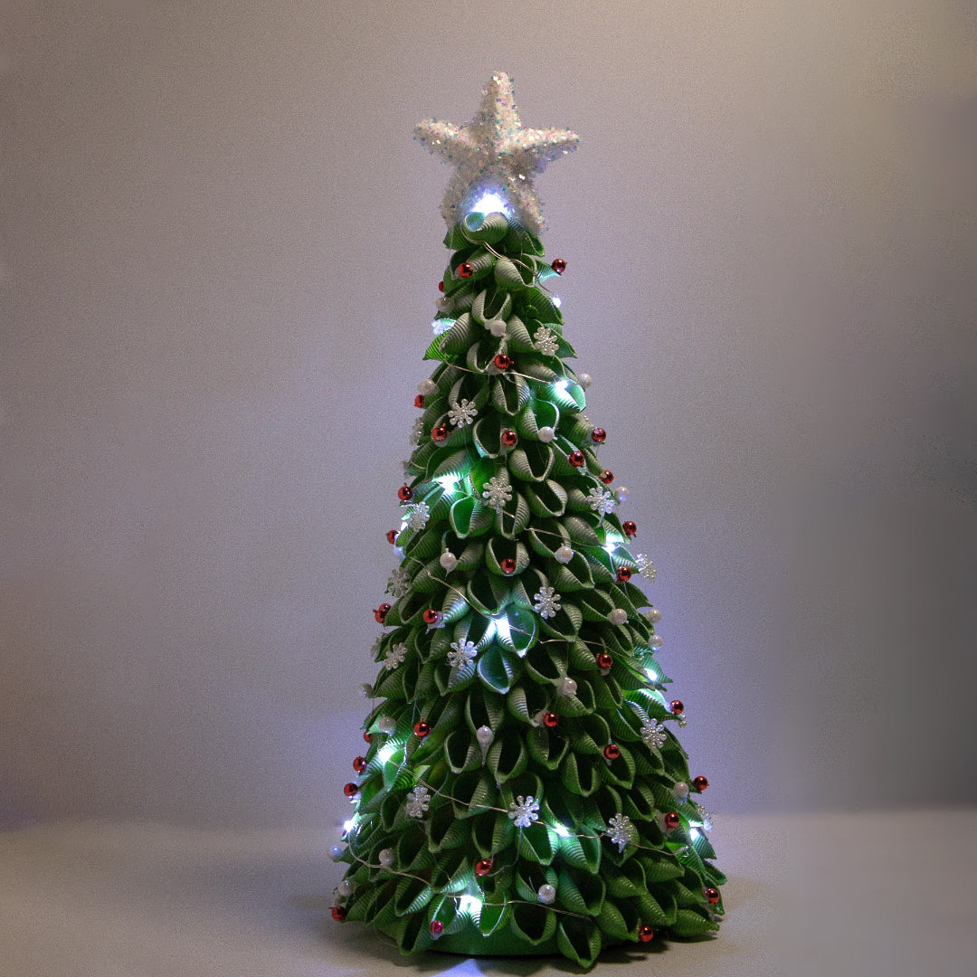 Green Christmas tree with white ornaments, white star and white lights