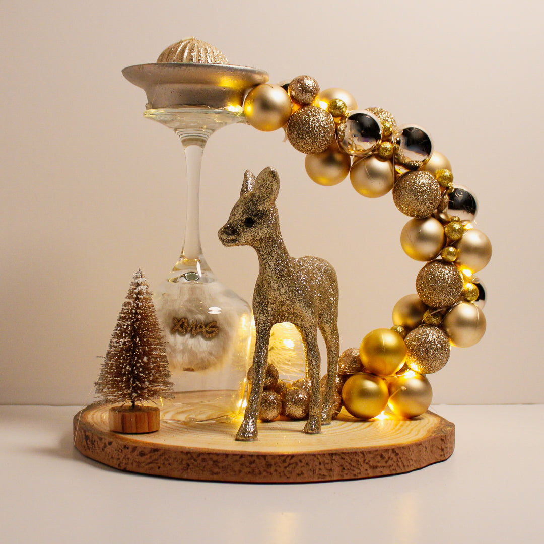 Beautiful Christmas decoration made of natural tree trunk, wine glass and ornaments